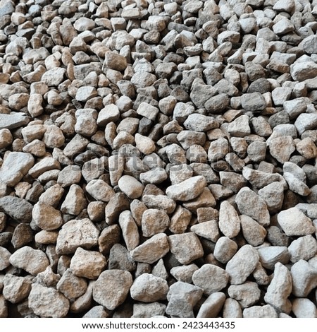 Pebbles are small rocks, usually broken granite. Gravel is often used in the construction of road bodies, and as a mixed stone to produce bricks. Royalty-Free Stock Photo #2423443435