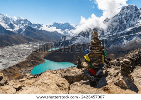 View of Village and Lake Gokyo, snow capped Cholatse, Taboche, Cholatse, Lhotse, Nuptse, Everest, Pumori of the Himalayas and Ngozumpa Glacier. View from Gokyo Ri, Solukhumbu, Sagarmatha, Nepal. Royalty-Free Stock Photo #2423457007