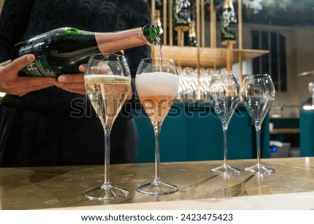 Pouring and tasting of sparkling wine champagne on winter weekend festival in December on Avenue de Champagne, Epernay, Champagne region, France Royalty-Free Stock Photo #2423475423