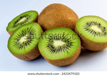 Kiwi fruits cut in half on a white background