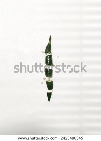 Green chili cut stock photo with white background.