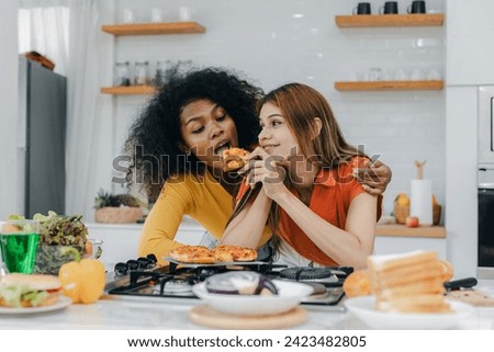 Pride LGBT Family at the kitchen Happy face. Preparing family dinner at home. Happy smiling family having fun cooking at kitchen together. Family lifestyle. Happy together cooking on kitchen. Royalty-Free Stock Photo #2423482805