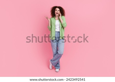 Full body size photo of smiling business lady look empty space having a phone call dialogue surprised isolated on pink color background