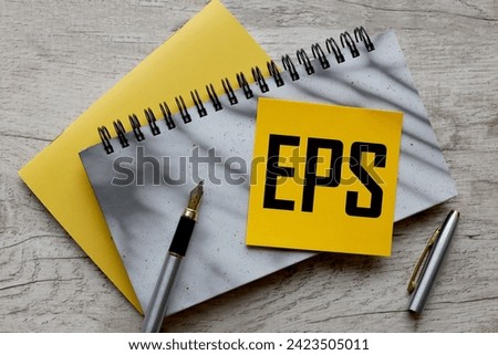 EPS text on a yellow sticker on a gray notepad