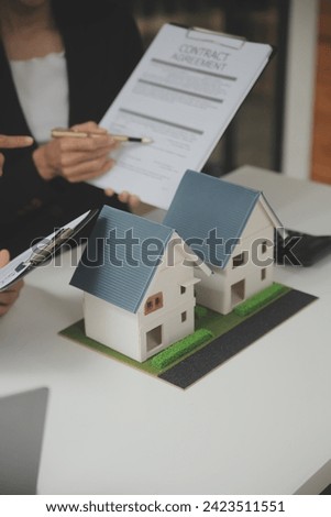 Business Signing a Contract Buy - sell house, insurance agent analyzing about home investment loan Real Estate concept.