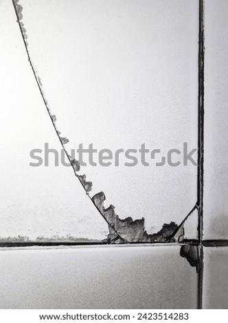 Top view of old ceramic floor tiles that have weather-related damage, cracks, and breaks Royalty-Free Stock Photo #2423514283