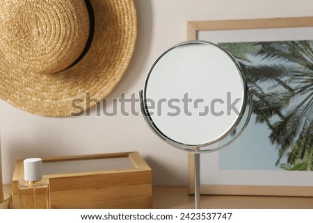 Mirror, perfume, hat and picture in room