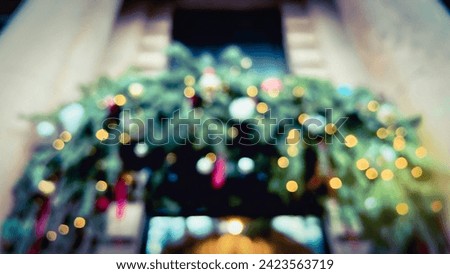Defocused Christmas ornaments upon entrance. Xmas wreathe with golden bokeh lights. Fir tree decoration in winter. Soft focus. film grain pixel texture. Defocused.
