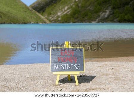 Easy money business symbol. Concept words Easy money business on beautiful black chalk blackboard. Beautiful mountain lake background. Easy money business concept. Copy space.