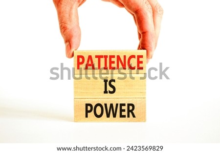 Patience is power symbol. Concept words Patience is power on beautiful wooden blocks. Beautiful white table white background. Businessman hand. Business and patience is power concept. Copy space.