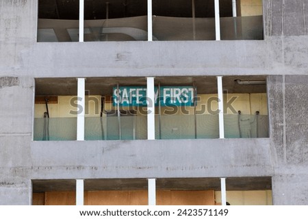 Old building dedicated to workers in construction sector in Dubai with sign "safety first"
