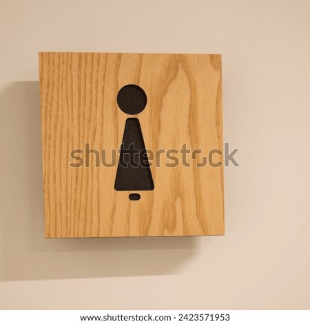 Female or woman toilet wood sign,Minimal design of women public toilet or restroom sign on the wooden plate stick