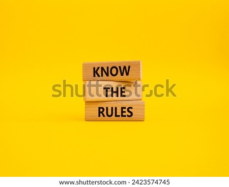 Know the rules symbol. Wooden blocks with words Know the rules. Beautiful yellow background. Business and Know the rules concept. Copy space.