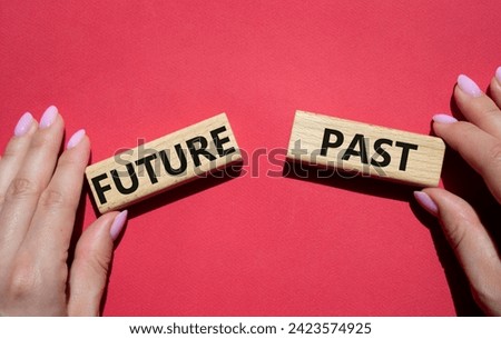 Future or Past symbol. Concept word Future or Past on wooden blocks. Businessman hand. Beautiful red background. Business and Future or Past concept. Copy space Royalty-Free Stock Photo #2423574925