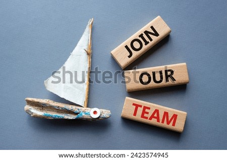 Join our team symbol. Wooden blocks with words Join our team. Beautiful grey background with boat. Business and Join our team concept. Copy space.
