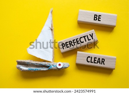 Be perfectly clear symbol. Concept words Be perfectly clear on wooden blocks. Beautiful yellow background with boat. Business and Be perfectly clear concept. Copy space Royalty-Free Stock Photo #2423574991
