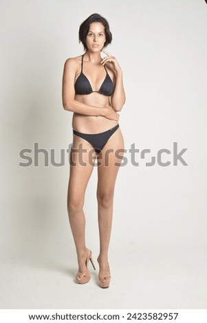 black bikini, woman short hair, tanned skin, white background, swimwear, body, beach, pool, vacation, natural.