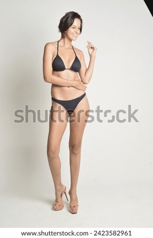 black bikini, woman short hair, tanned skin, white background, swimwear, body, beach, pool, vacation, natural.