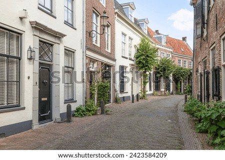 Narrow old street with wall houses in the old part of Amersfoort. Royalty-Free Stock Photo #2423584209