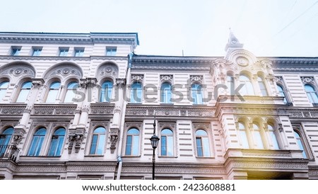 Historic building with dragons as ornaments in centre of Saint-Petersburg Russia. Travel St. Petersburg. Yellow toning. Soft focus. film grain pixel texture. Defocused.