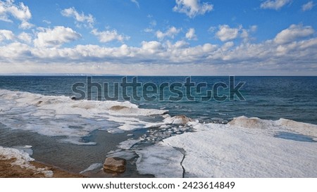 Drone shot of Georgian Bay Ice Pack Breaking Up and Melting in February when unseasonably warm Royalty-Free Stock Photo #2423614849