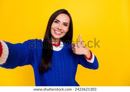 Selfie of young brunette latin cheerful lady in blue knit jumper rate good feedback likes photo camera isolated on yellow color background