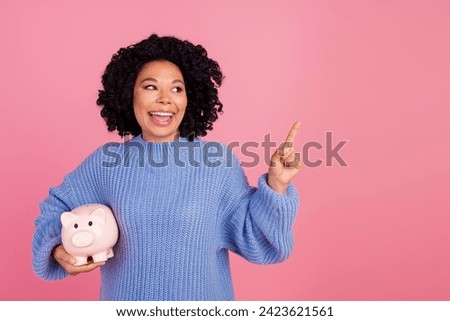 Photo portrait of lovely young lady piggy point look empty space dressed stylish blue knitted garment isolated on pink color background