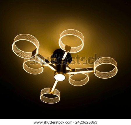 An elegant chandelier with 6 arms in the shape of circles, illuminated with warm LED light, adds brightness and refinement to any interior. Its contemporary design and warm light provide a pleasant