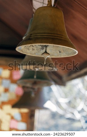 A lot of hanging bells in a church.