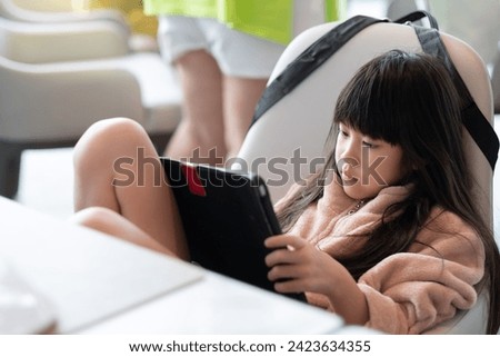 Kid watching tablet on the food table, children addicted cartoon

