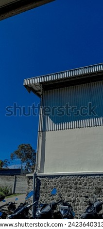 a building where people work to earn money with all their hearts is bright like the blue sky Royalty-Free Stock Photo #2423640313
