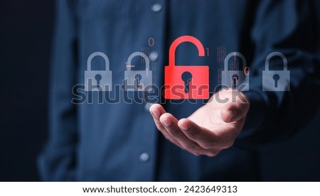 Hacker attack and data breach, information leak concept. Person hold virtual red padlock icon with broken lock.