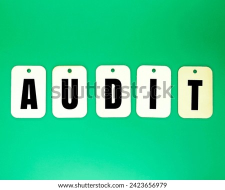 wooden tag with the word audit. an official inspection of an organization's accounts
