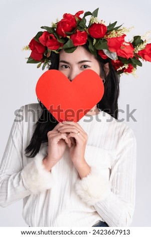 woman hoad cartoon red heart paper, put rose on head stand white background,for good health or tell love in valentine day. Royalty-Free Stock Photo #2423667913
