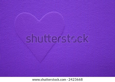 Purple heart shape raised on a purple striped fabric background.