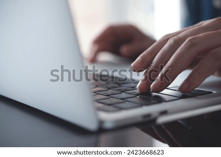 Close up of business woman hands typing on laptop keyboard on table, online working from home office, searching the information on internet network, e-learning, telecommuting concept