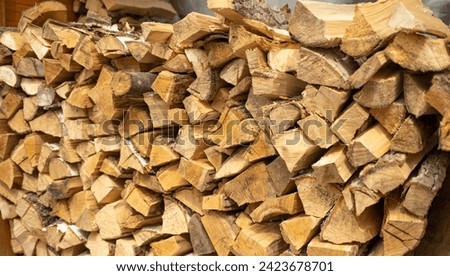 Firewood from chopped logs for heating the house. wooden background