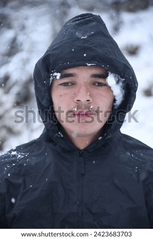 Picture of Indian teenager boy with snow backround