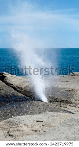 Natural fountain caused by waves entering coral gaps like whales breathing on the south coast of Java