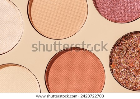 Vivid colored eye shadow makeup palette close up, colorful swatches cosmetic and beauty product, shiny eye shadow in beige package, aesthetic background textures powder for eye cosmetics, close up Royalty-Free Stock Photo #2423722703