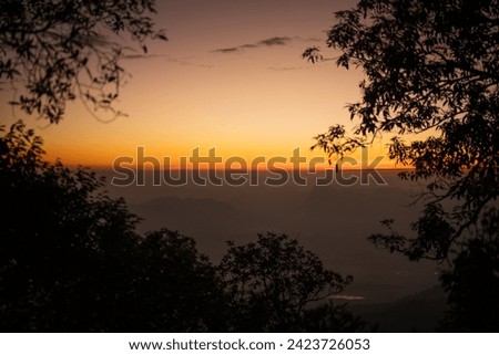 silhouette of trees foreground with sunrise or sunset. at Pru Kradueng Thailand.