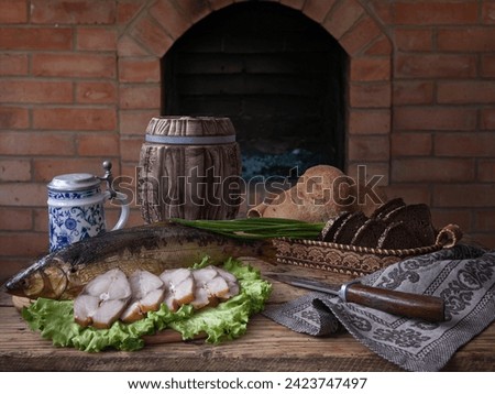 Still life with smoked fish and beer