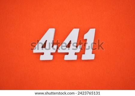 Orange felt is the background. The numbers 441 are made from white painted wood. Royalty-Free Stock Photo #2423765131