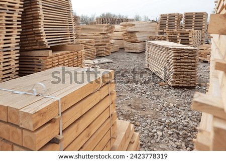 Wooden pallets for transportation of building materials. Stack of pine planks. Woodworking industry.