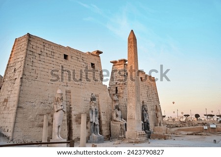 Obelisk and statues of Ramses II at the first pylon of the Luxor Temple. Statue of the great Egyptian Pharaoh in luxor temple ,Egypt
