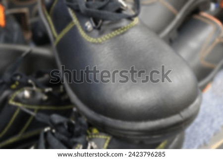 Blurred photo of an old black leather shoe, this photo can be used as a background photo