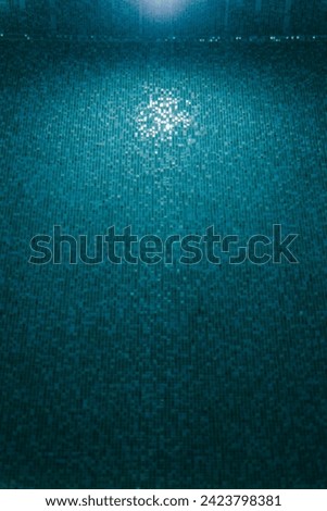 Mosaic bottom and lamp with light of underwater pool. Under water in swimming pool. Photo of swimming pool. Sport, vacation and relax concept. Summer background. Texture of water surface. Down view.