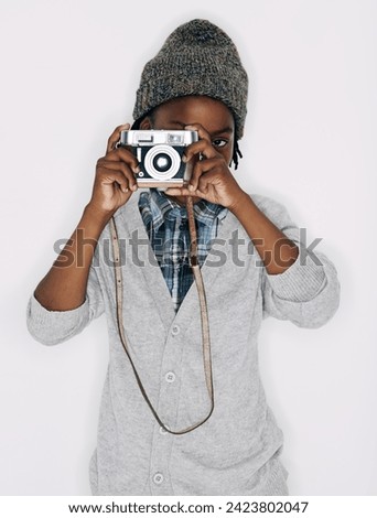 Photographer, portrait or child in studio with camera isolated on white background for creative talent. Photography, African boy or cool kid artist with hobby, style or picture ready for photoshoot