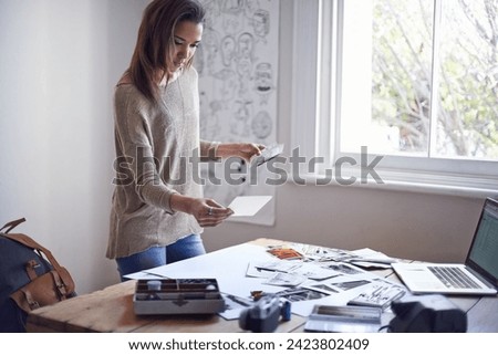 Woman, photographer and picture prints in creative studio for project planning for proposal, mood board or film roll. Female person, images and thinking for art portfolio for job, career or decision