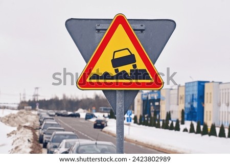Soft verges, Warning sign, traffic sign and cars parked in row along dangerous snowy roadside on background. Soft verge road sign, car parked with traffic violation. Dangerous parking on soft roadside Royalty-Free Stock Photo #2423802989